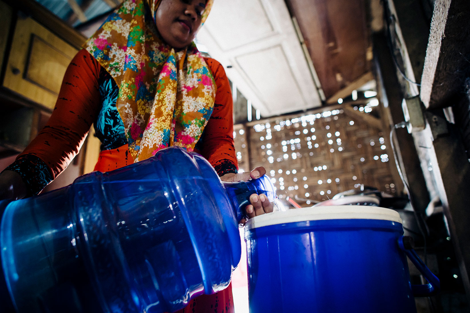 A mother collects safe water for her family in Indonesia.