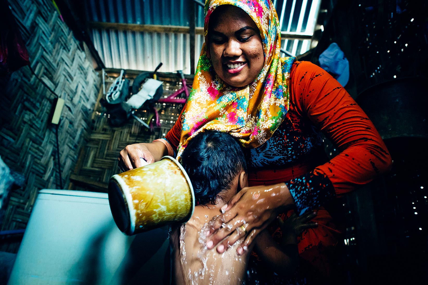 Hayani baths her son with safe water.