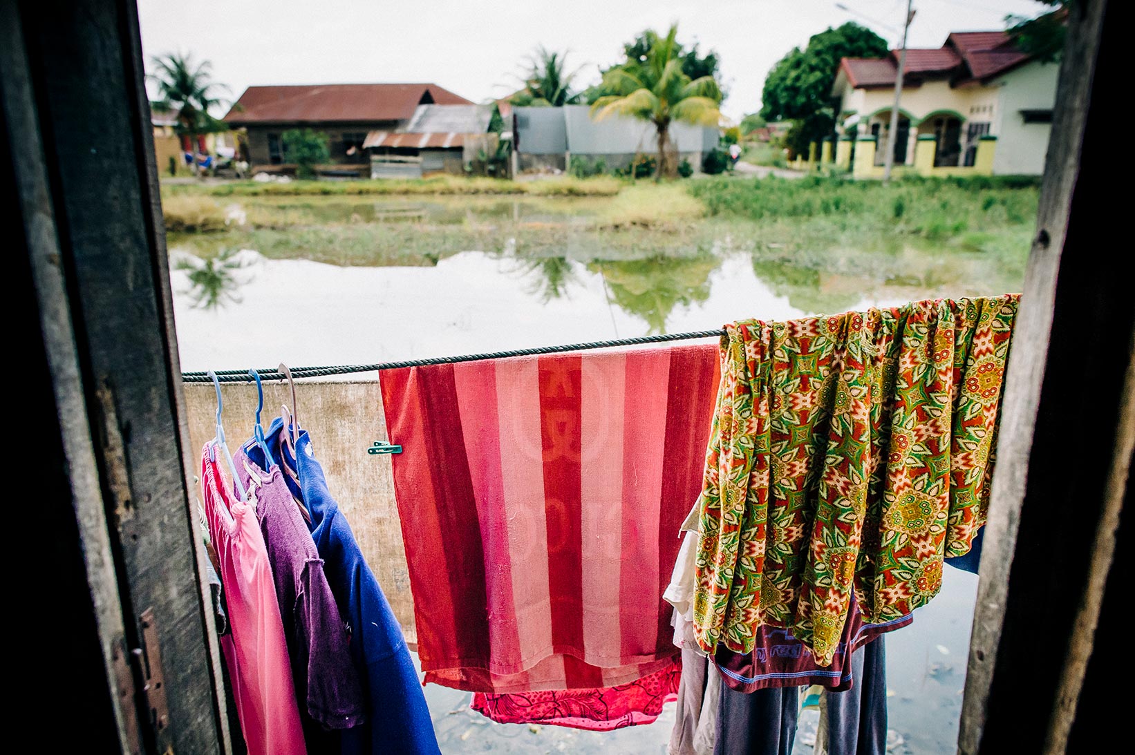 Clothes hang up to dry outside a woman's home in Indonesia.