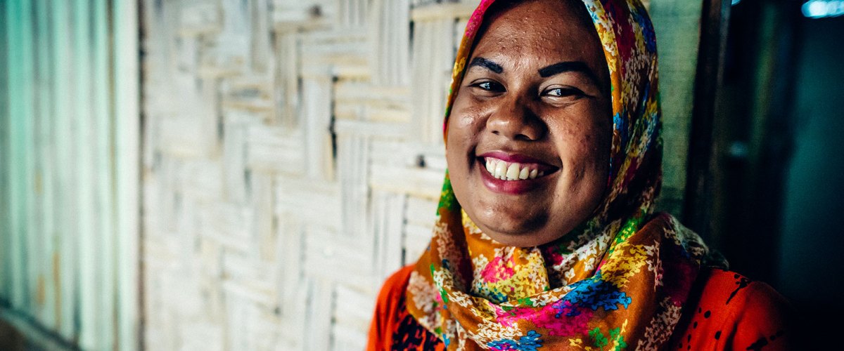 A mother in Indonesia smiles after receiving safe water.